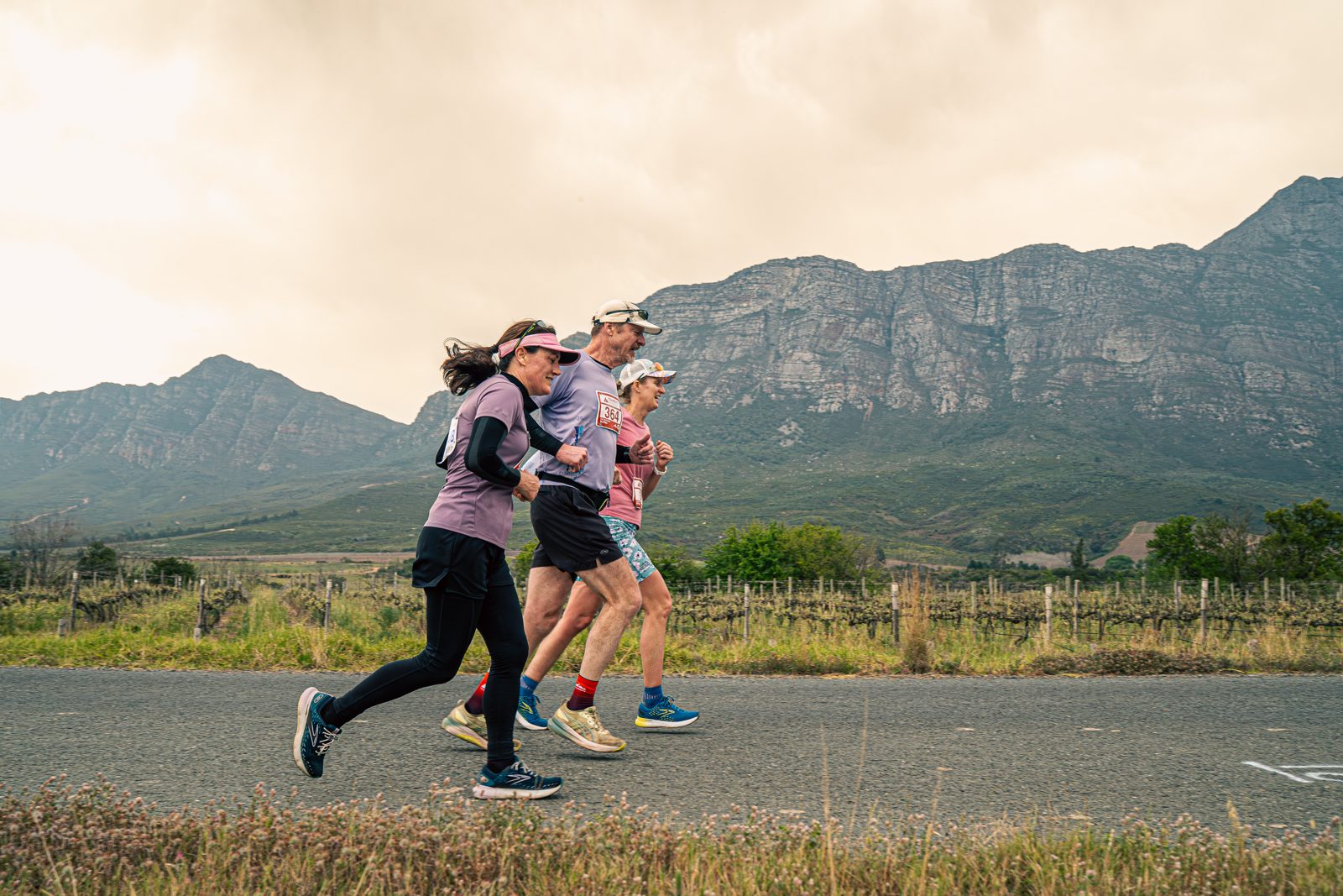 Runners training together below the mountains